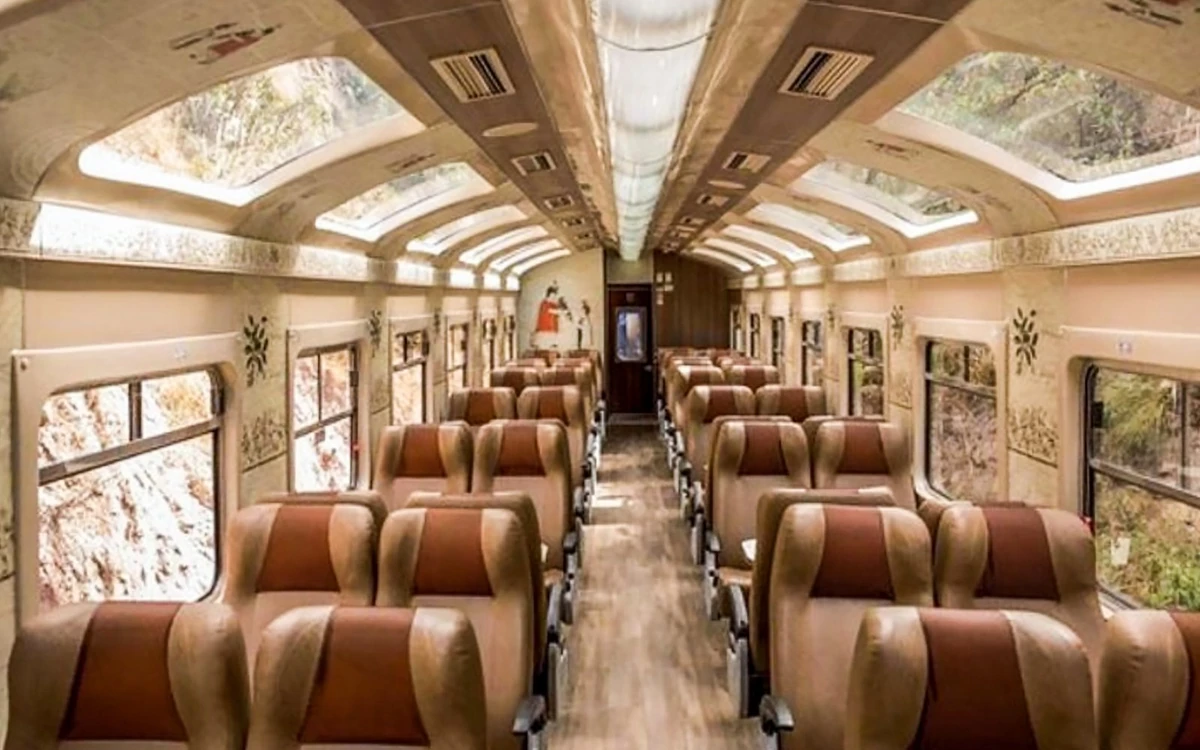 Rows of tan and rust-brown seats along a carriage aisle under roof windows