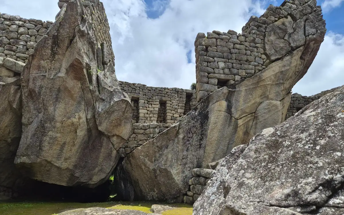 Two huge tilted granite rocks set into walls of fitted stone